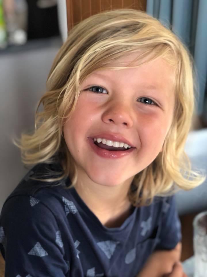 Hamish smiling as a young child