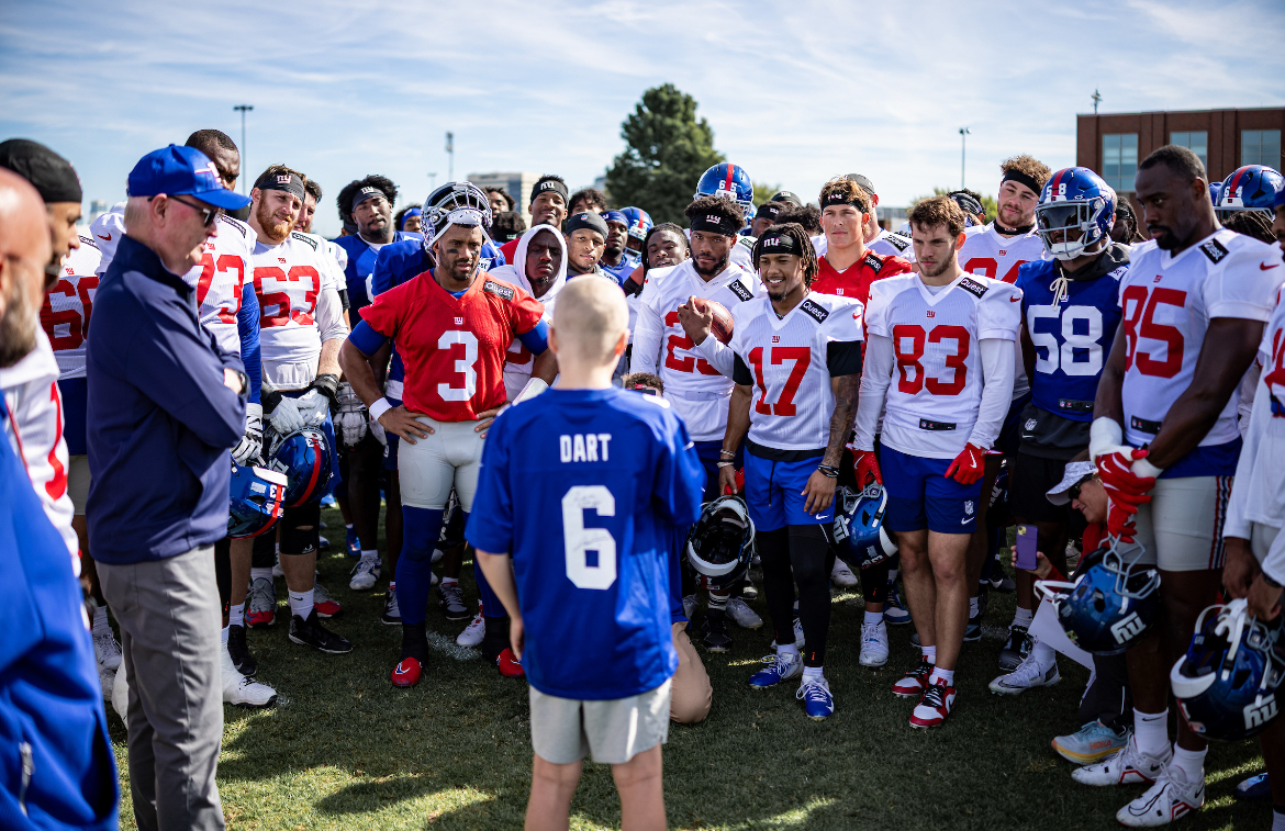 Hamish standing with the New York Giants team at practice