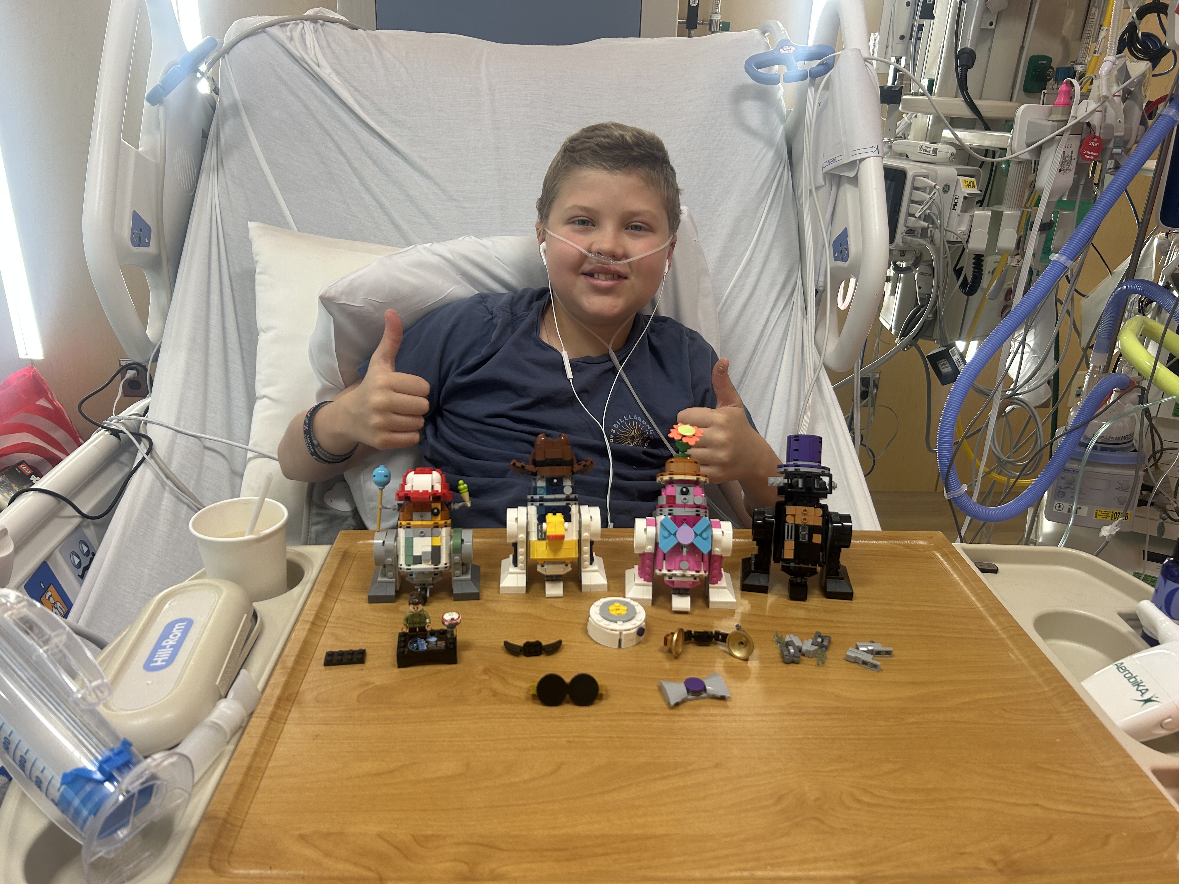 Hamish smiling with a companion in a hospital room